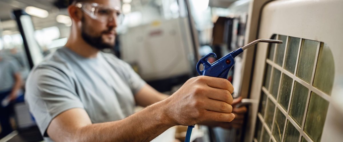 close-up-worker-operating-industrial-machine-factory